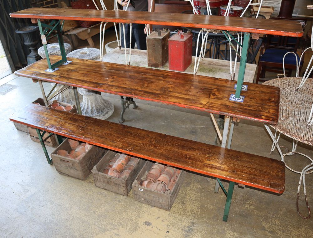 A vintage pine and metal folding garden table and two benches, table W.220cm, D.50cm, H.77cm